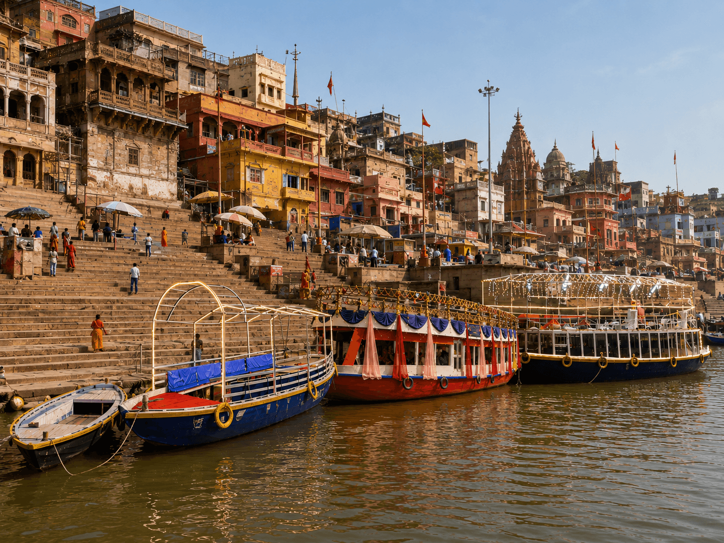 All four boat types docked at a ghat, daylight