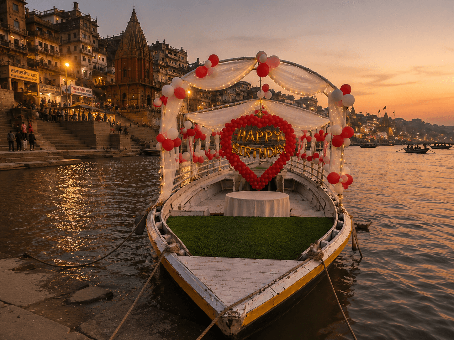 Fully decorated boat — balloon arch, banner, cake table, golden hour